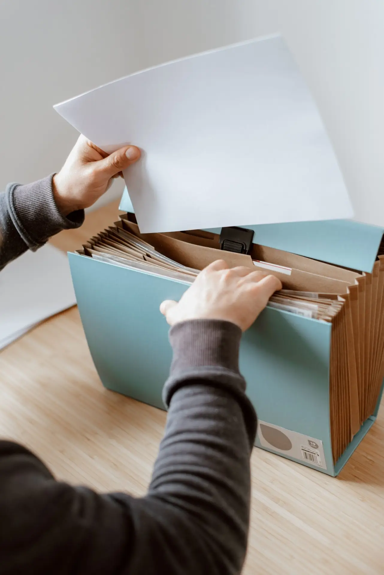 Writing a Will in Poole and Bournemouth? Get in Contact Today Person organising documents in folder