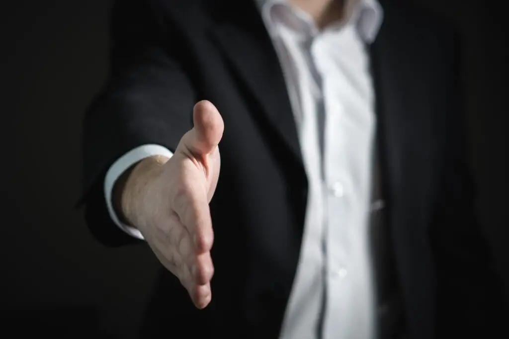 Writing a Will in Poole and Bournemouth? Get in Contact Today Businessman extending hand for handshake
